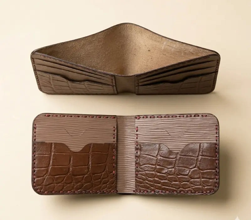 Brown leather wallet with crocodile texture on a beige background