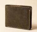 Brown leather wallet on a beige background