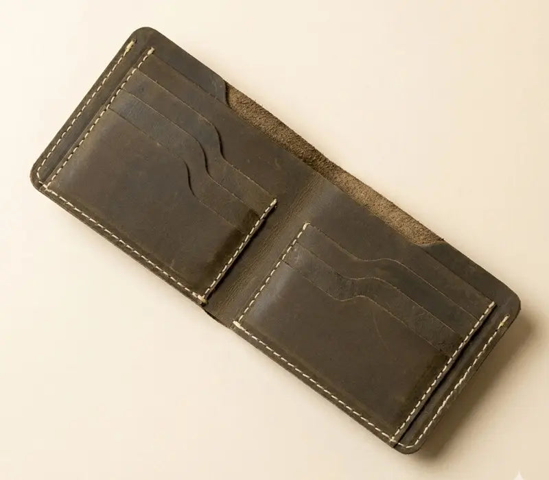 Brown leather wallet on a beige background