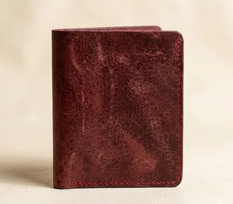 Brown leather wallet on a beige background