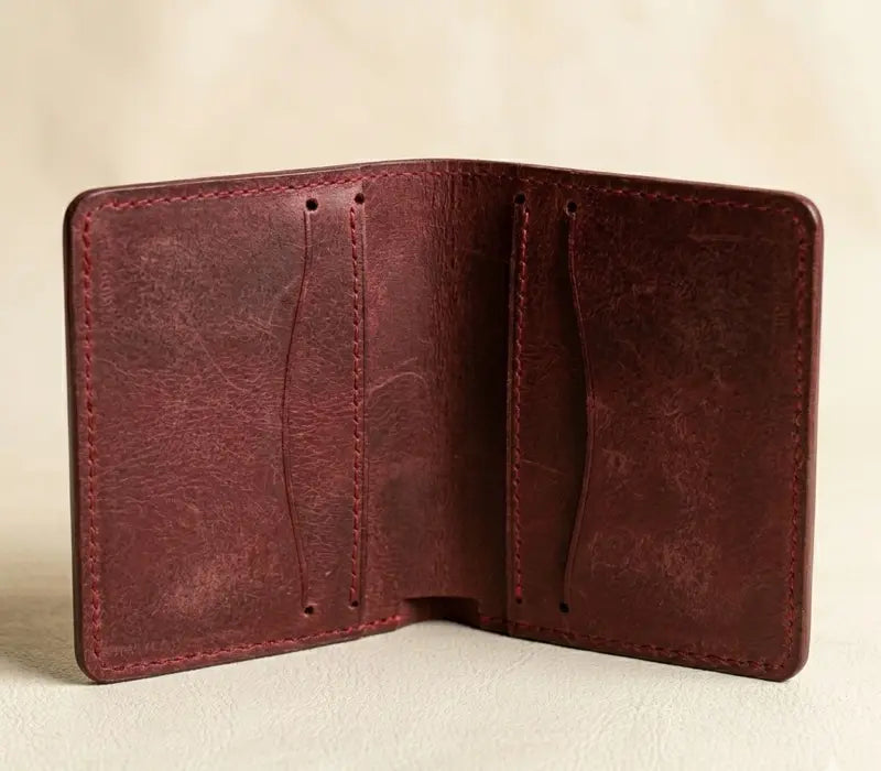 Brown leather wallet on a beige background