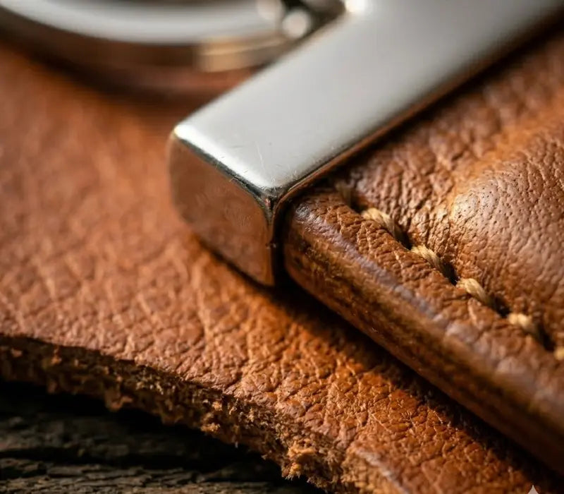 Close-up of a brown leather key fob with a silver keychain.