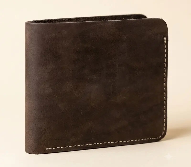 Brown leather wallet with white stitching on a beige background