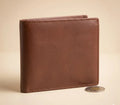 Brown leather wallet with a coin on a beige background