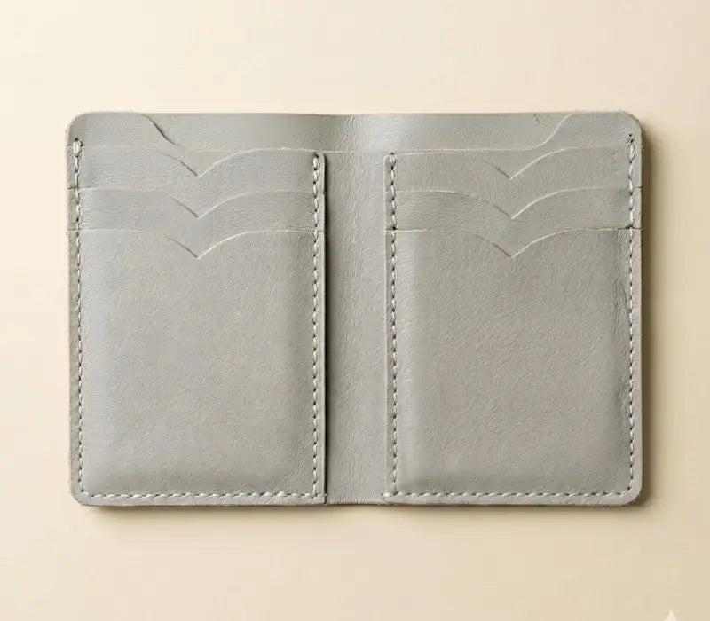 Gray leather wallet on a beige background