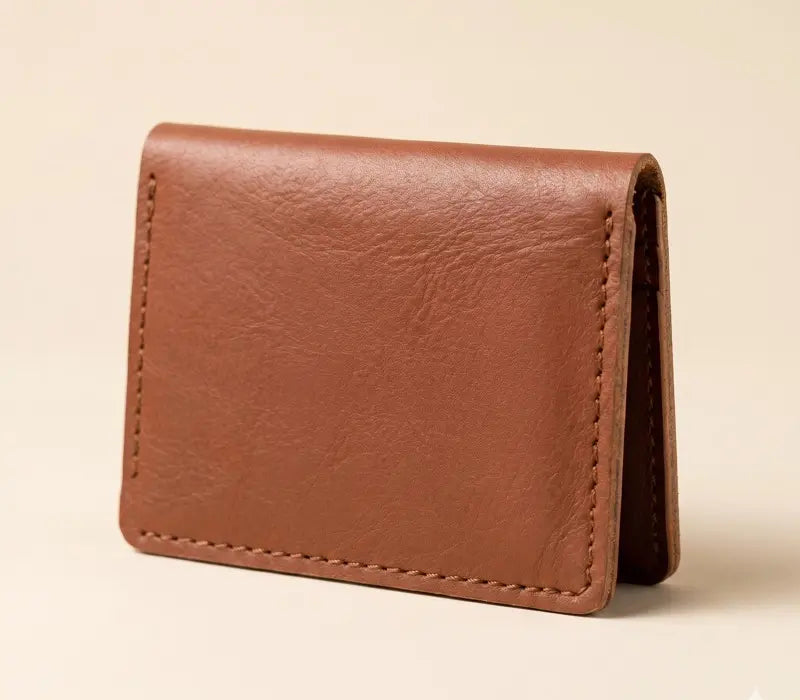Brown leather wallet on a beige background