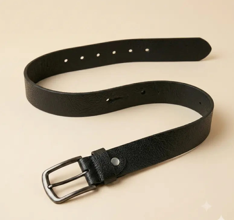 Black leather belt with a silver buckle on a beige background