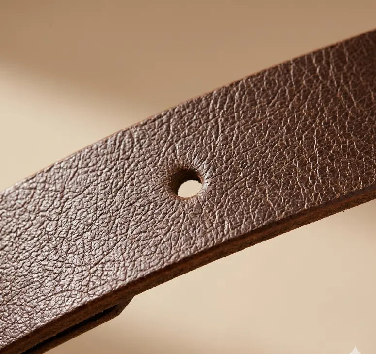 Close-up of a brown leather belt with a visible hole on a beige background