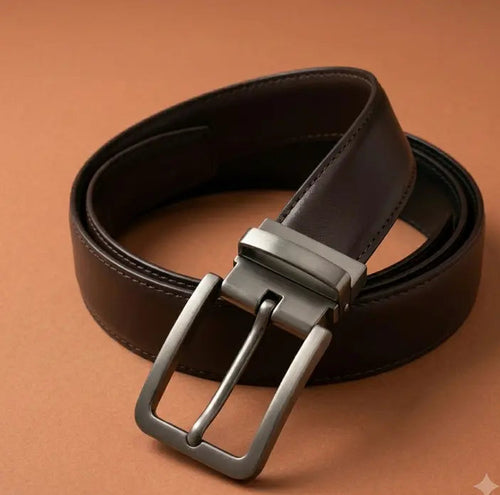 Brown leather belt with silver buckle on a brown background