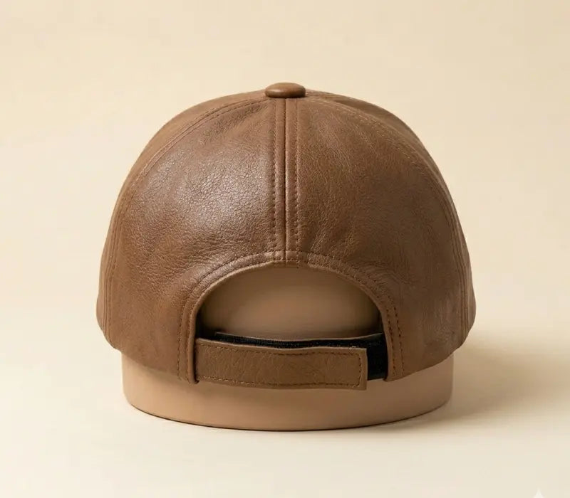 Brown leather cap on a beige background