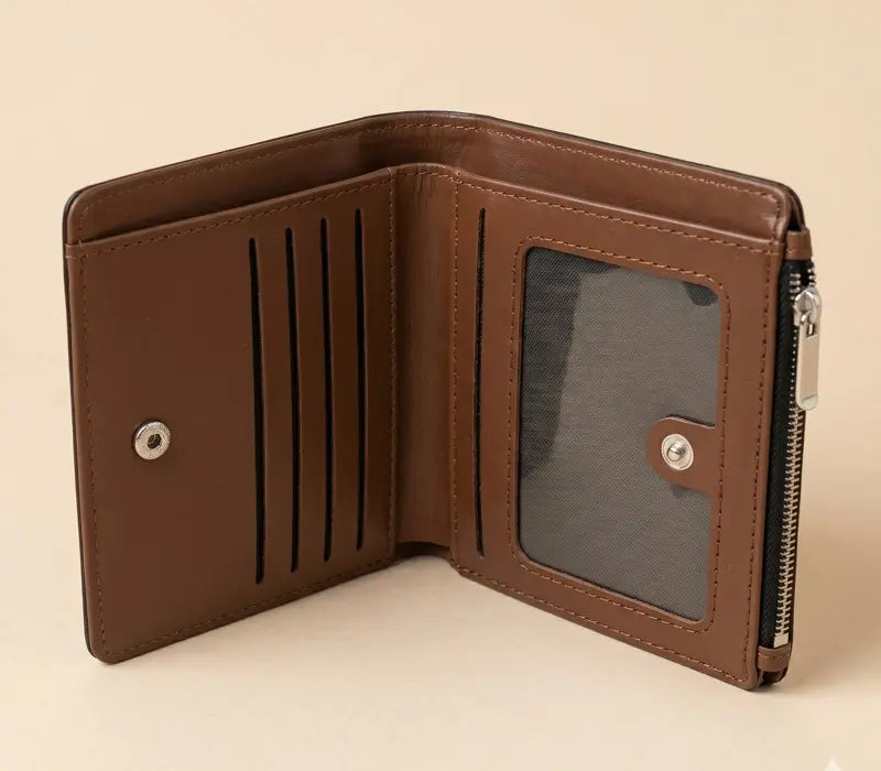 Brown leather wallet with card slots and a zipper pocket on a beige background