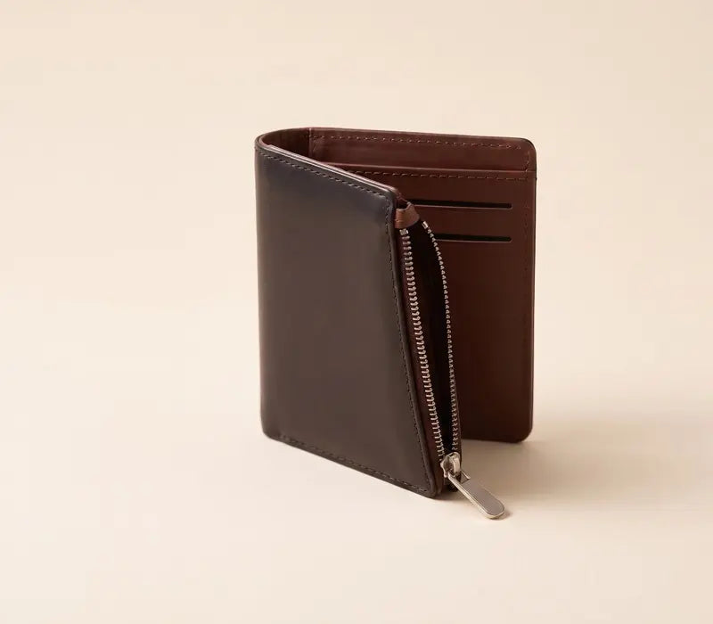 Brown leather wallet with a zipper on a beige background