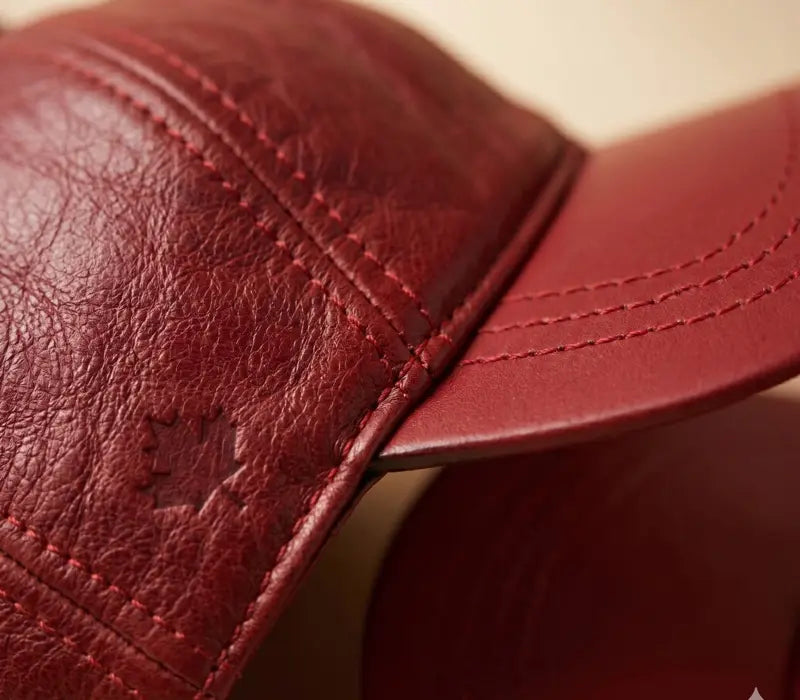 Close-up of a red leather cap with visible stitching