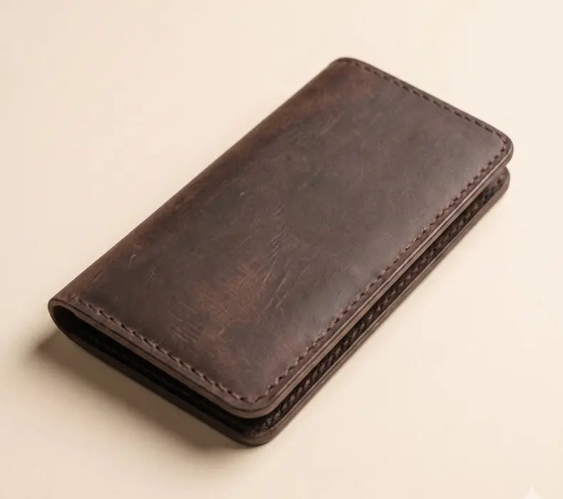 Brown leather wallet on a beige background