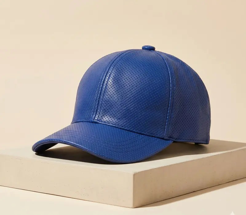 Blue textured baseball cap on a beige surface