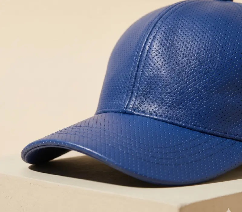 Blue leather baseball cap on a beige background