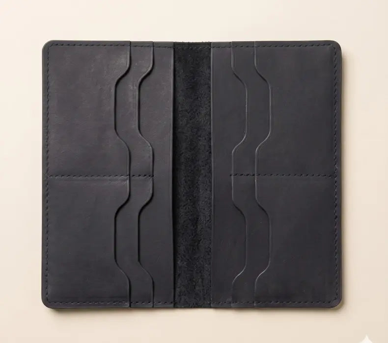 Black leather wallet with card slots on a beige background