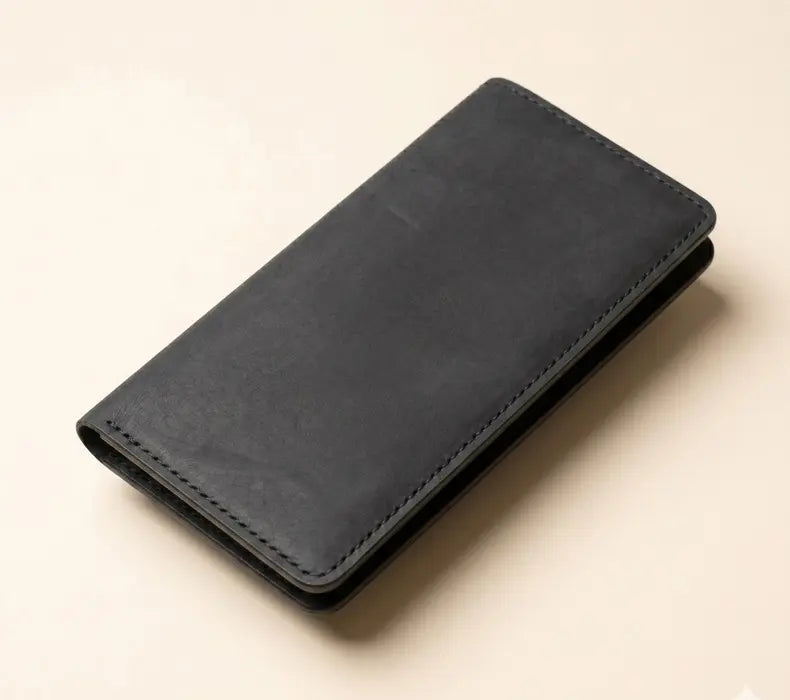 Black leather wallet on a beige background