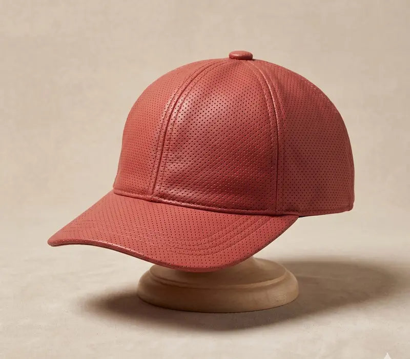 Red textured baseball cap on a beige stand against a beige background