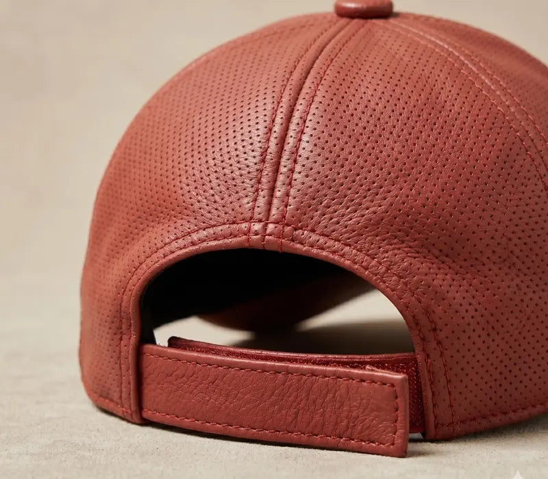 Close-up of a red leather cap on a beige background