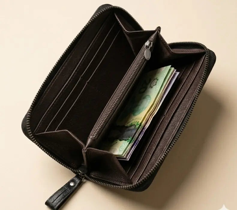 Open brown leather wallet with money on a beige background