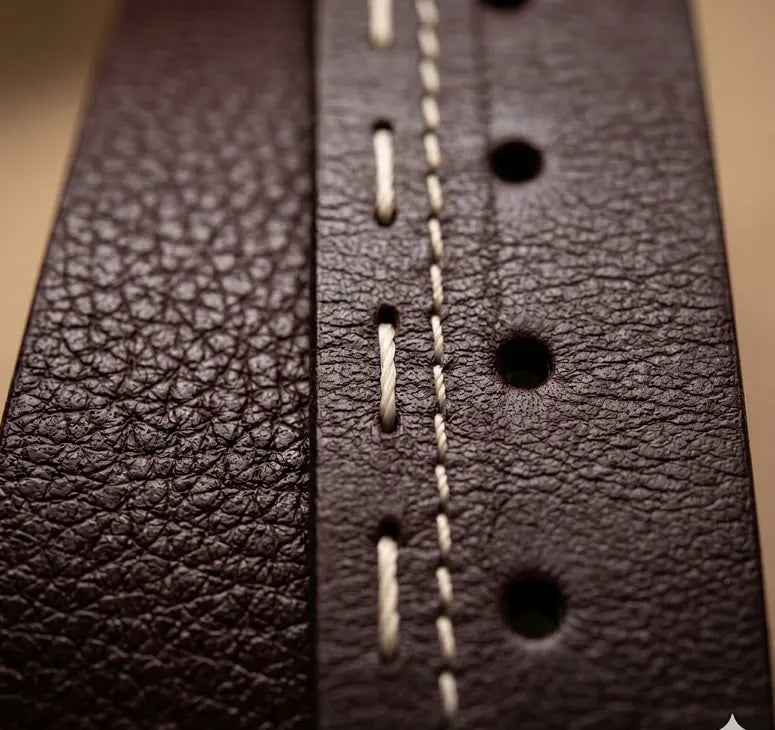 Close-up of a brown leather belt with visible stitching