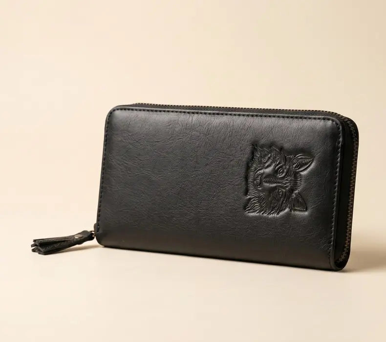 Black leather wallet with tiger emblem on a beige background