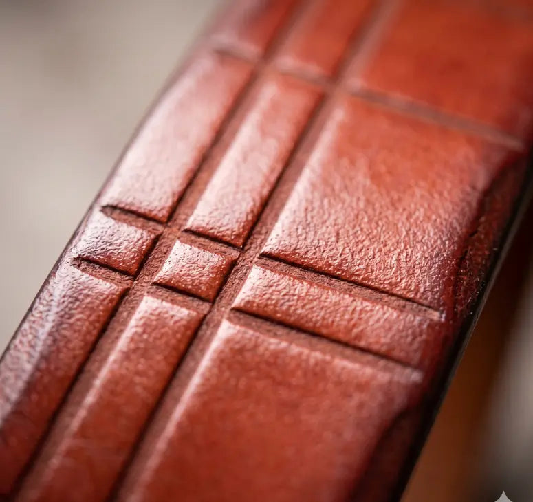 Close-up of a brown leather wallet with embossed design