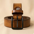 Brown leather belt with a black buckle on a beige background