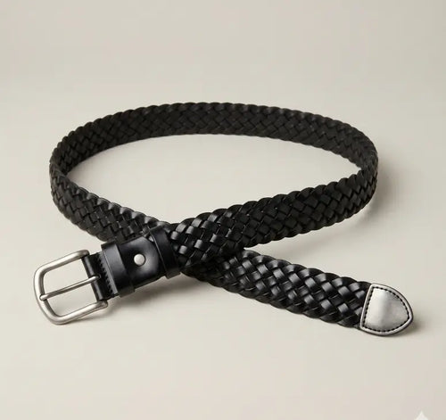 Black braided belt with a silver buckle on a beige background