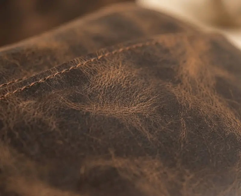 Close-up of brown leather texture with visible stitching