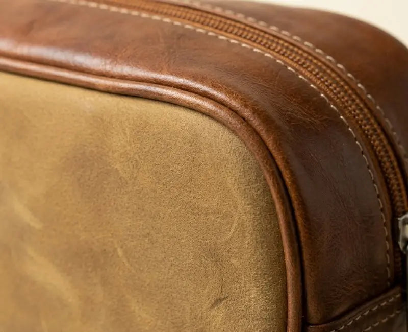Close-up of a brown leather bag with visible stitching