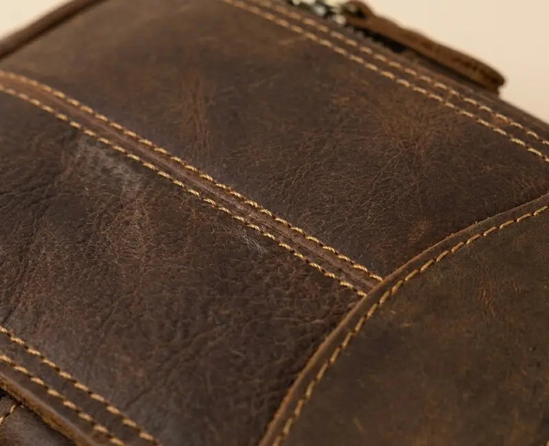 Close-up of a brown leather bag with visible stitching